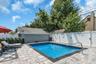 In-ground swimming pool 3' to 6' featuring custom paver perimeter patio
