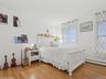 Bedroom featuring wood-type flooring and a baseboard radiator