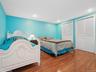 Bedroom with two closets and hardwood / wood-style flooring