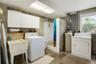 Laundry area with shower in garage