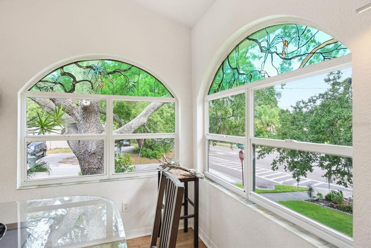 Dining Room custom stained glass created to mimic the oak tree coming in from the outside and windowsills lined with custom handmade fused glass tiles