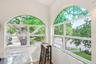 Dining Room custom stained glass created to mimic the oak tree coming in from the outside and windowsills lined with custom handmade fused glass tiles