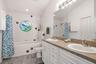 En Suite Primary bathroom with double vanity & linen closet..