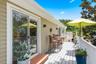 Living room and Primary Bedroom sliders lead to upstairs Trex deck overlooking landscaped backyard.