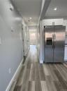 Corridor featuring light wood-type flooring and recessed lighting