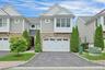 Elegant three-level townhouse in the sought-after Hidden Ridge community, offering a rare combination of elevator access to all levels, a two-car atta