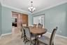 Flex Room with Crown Molding, Chandelier, and Barn Door Entry to Butler's Pantry