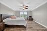 Primary Suite with LVP Floors, Crown Molding, Ceiling Fan, En-Suite Primary Bathroom, Windows Overlooking the View in Waterleaf Community! Enough Room