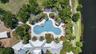 Aerial View of Amenities with Clubhouse, Resort Style Pool, Playground/Park, Sports Court, Dog Park, Walking Trails and Water View in Waterleaf Commun