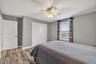 Bedroom #4 with LVP Flooring, Ceiling Fan, Built-In Closet, Accent Wall and Window Overlooing the Pond and View of Waterleaf Community!