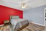 Bedroom #4 with LVP Flooring, Ceiling Fan, Built-In Closet, Accent Wall and Window Overlooing the Pond and View of Waterleaf Community!