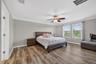 Primary Suite with LVP Floors, Crown Molding, Ceiling Fan, En-Suite Primary Bathroom, Windows Overlooking the View in Waterleaf Community! Enough Room