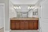 Primary En-Suite Bathroom with Dual Vanities, Granite Countertops, Garden Soaking Tub with Window, Shower Stall with Glass Frame, Private Water Closet