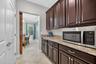 A True Staging Area! An Entertainer's Dream! Butler's Pantry with Barn Door Entry and Access to Kitchen and Flex Room. Double Door Pantry Closet.