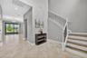 Foyer with Cathedral High Ceiling, View to Tranquil Pond, Alcove, and Staircase