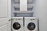 Upstairs Inside Laundry Room with Custom Cabinet, Shelving, and GE Washer & Dryer