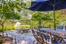 View of patio with a fire pit and outdoor dining space