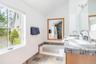 Primary ensuite with double vanity, bathtub, and shower
