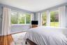 Primary ensuite bedroom with walk in closet and built in shelving