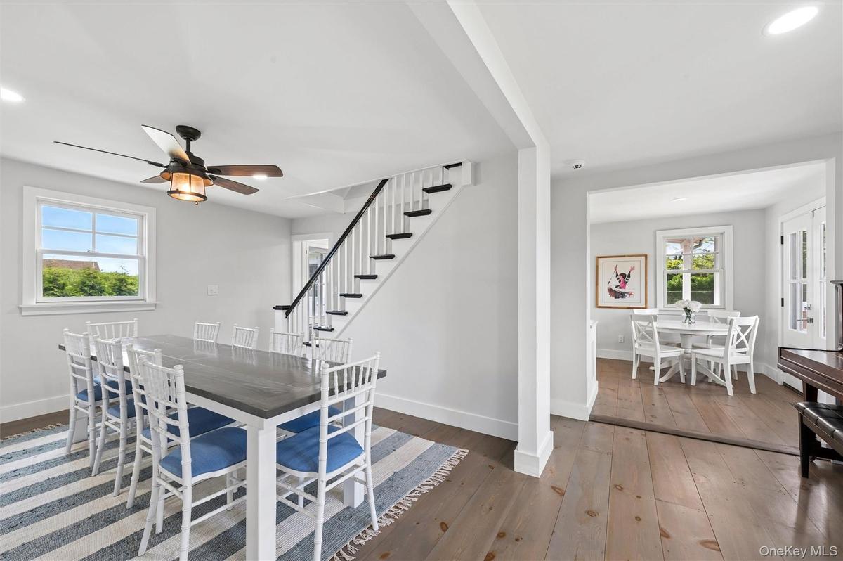 Staircase divides dining and kitchen areas.