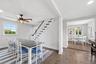 Staircase divides dining and kitchen areas.