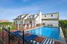 Summer entertaining area with patios for dining and relaxing, outdoor shower, and pool.