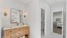 Primary ensuite bath with two walk in closets and two vanities