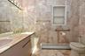 Double sinks and tile flooring and walls
