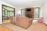 Family Rm with wood burning fireplace and bright arched windows
