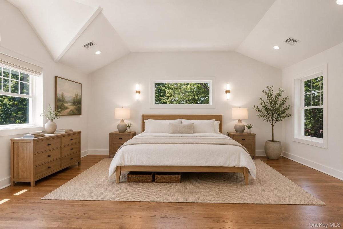 Primary Bedroom Suite with high ceilings, WIC and hardwood floors. 3 exposures