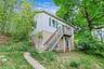 separate structure with cathedral ceilings, studio with bath upstairs, large storage downstairs.
