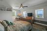 huge primary bedroom with open river and bridge views and access to the deck