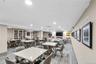 Spacious common area featuring guest, remote work options. Kitchenette, living area, recessed lighting, built-in shelving, and wall-mounted artwork id