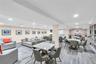 Spacious library with lounge area with Kitchen, Gas Fireplace featuring wood-finish flooring, recessed lighting, and multiple distinct work, play and 