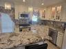 Kitchen featuring cream-colored cabinetry with decorative molding