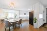 Dining area with light wood-type flooring, crown molding, and a chandelier