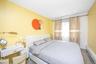 Bedroom featuring a baseboard heating unit, recessed lighting, and wood finished floors