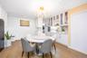 Dining room with stacked washer and clothes dryer, light wood-style floors, a chandelier, crown molding, and recessed lighting