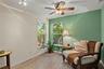 Spacious primary bedroom retreat featuring a bright and airy layout with a comfortable sitting area, creating the perfect space for relaxation and pri