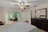 Spacious primary bedroom retreat featuring a bright and airy layout with a comfortable sitting area, creating the perfect space for relaxation and pri