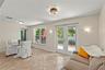 Versatile Florida room filled with natural light, offering the perfect space for a dining area, sitting room, home office, or additional living space.