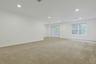 An expansive recreation room provides endless possibilities for a media room, playroom, fitness space, or home office, with ample room for multiple se