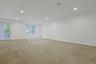 Bright and spacious with recessed lighting and oversized windows, this versatile lower-level living space is ideal for entertaining, relaxing, or work