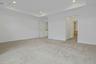 A serene owner's retreat featuring plush carpeting, a tray ceiling, and direct access to two walk-in closets and the luxurious ensuite bath.
