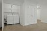 Conveniently located on the lower level, the dedicated laundry area accommodates a full-size washer and dryer and offers practical storage space for h