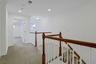 A spacious second-floor landing connects the bedroom level and creates an airy sense of openness, while providing convenient access to the elevator an