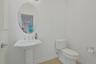 Conveniently located on the main level, this bright powder room offers classic finishes and easy access for both residents and guests.
