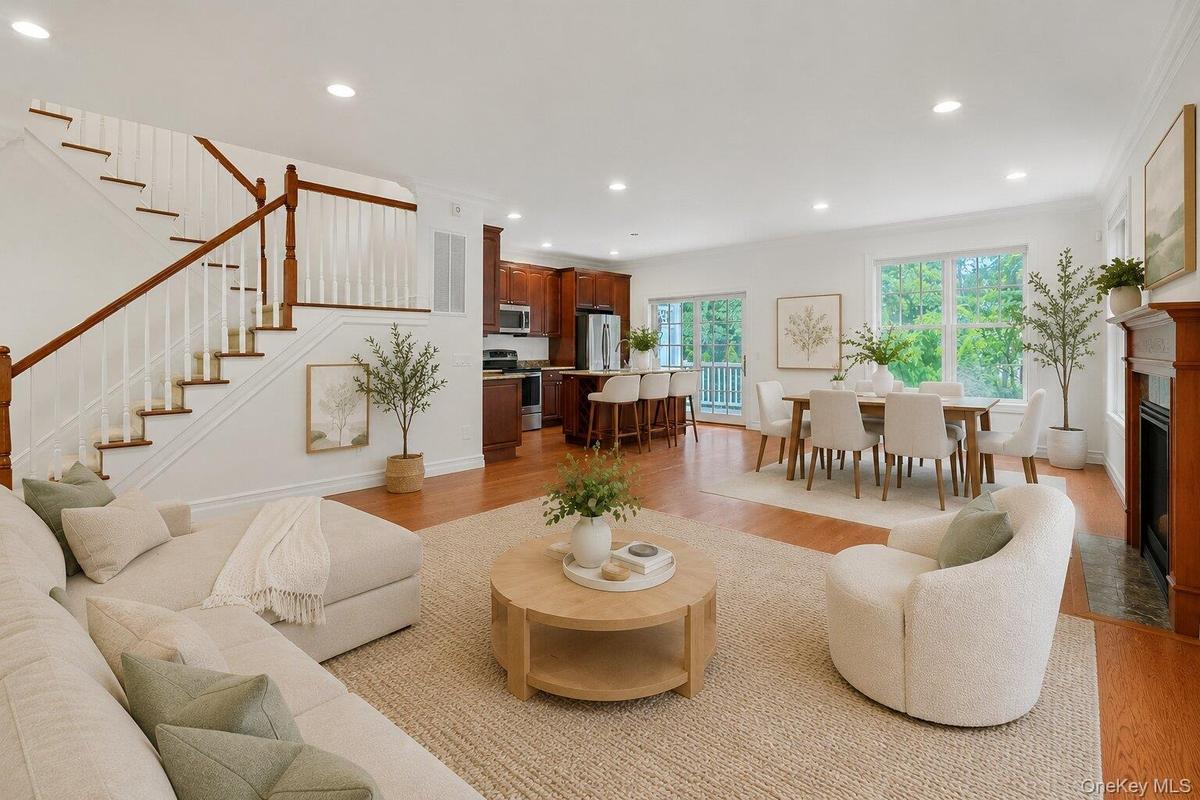 Sun-filled and spacious, the main level is designed for modern living with oversized windows, hardwood floors, a gas fireplace, and seamless flow betw