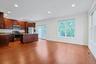 Well-appointed with rich wood cabinetry, granite countertops, stainless steel appliances, and a center island with seating.