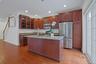 Sliding glass doors connect the kitchen to the private Trex deck, creating the perfect setting for outdoor dining or morning coffee surrounded by gree